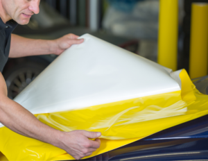 vinyl material getting installed on commercial vehicle.